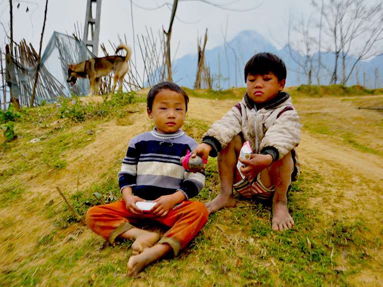 A group of boys were playing with wooden spinning tops